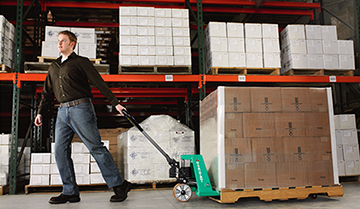 Man Pulling a Load with a Mitsubishi Hand Pallet Truck